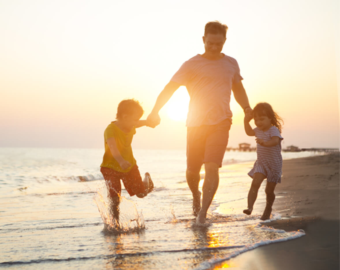 Leisure Travel Dad With Kids on Beach at Sunset